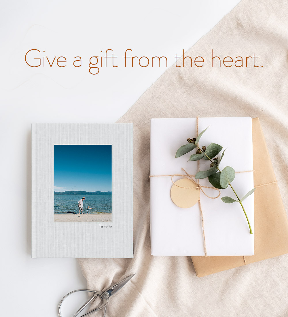 Give a gift from the heart. Photo Book next to a gift.