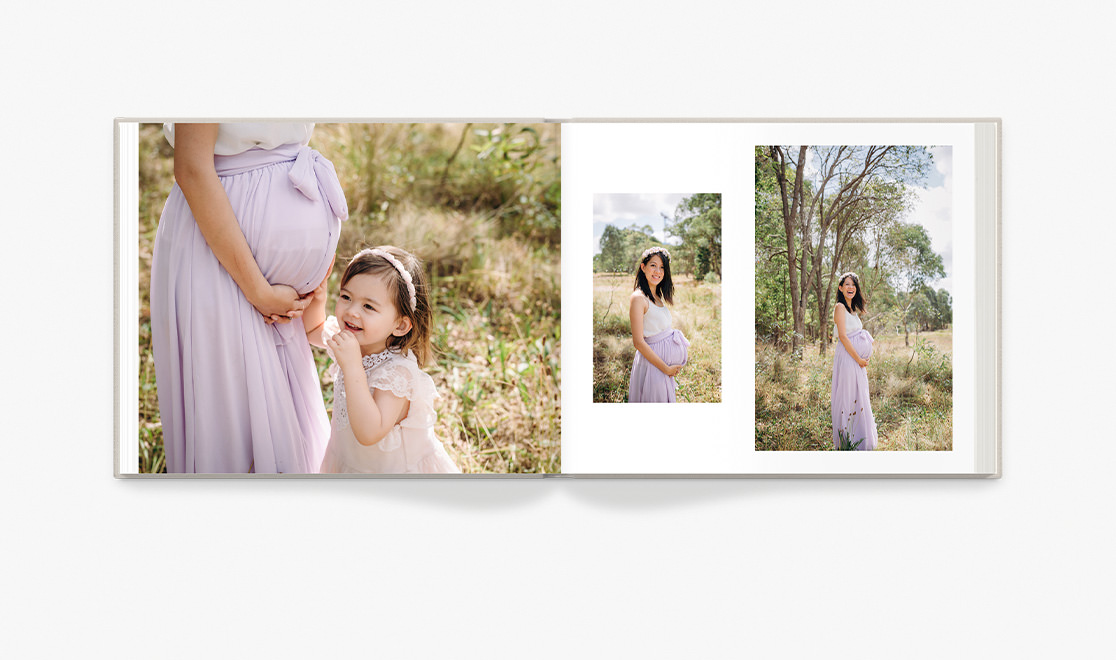 Open photo book displaying photos from a maternity shoot