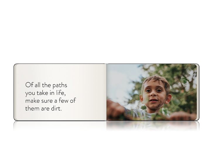 Open photo book showing spread with photo and caption