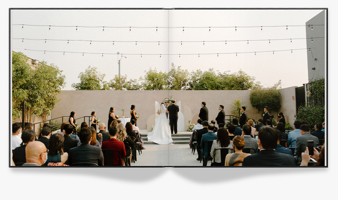 Open Photo Book showing photo of wedding ceremony with guests