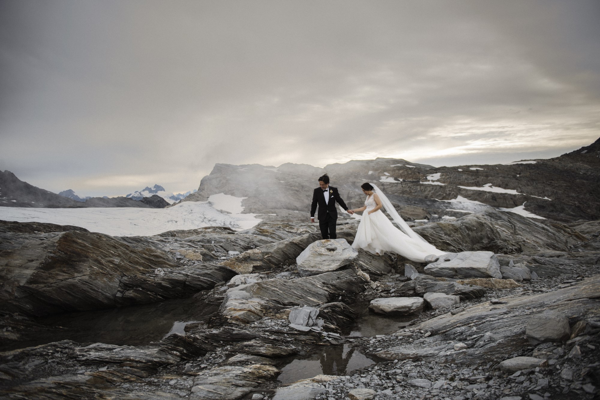 Newlyweds trek across rocky landscape