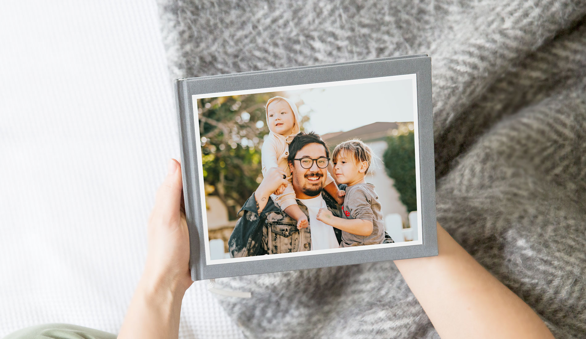 Father's day photo book with cover image of a dad and his two children.
