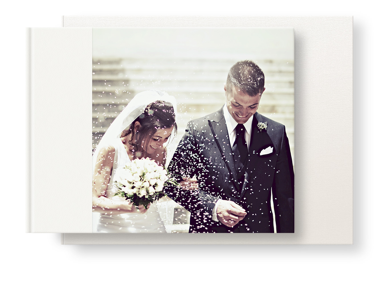 Presentation box and a landscape wedding album with a cover image of a bride and groom on their wedding day.
