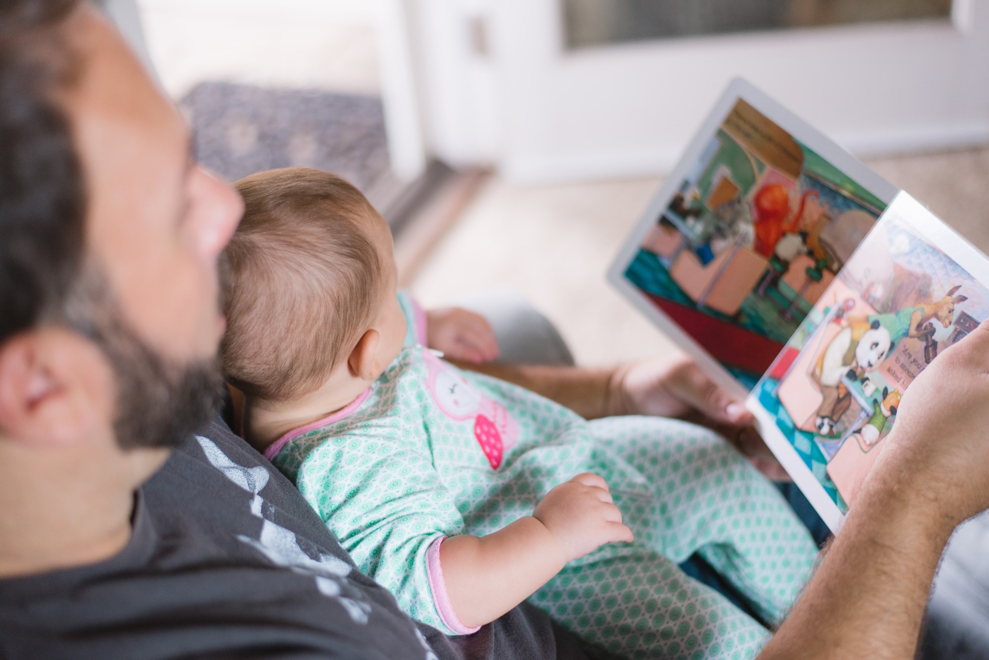 Father and baby reading a picture book