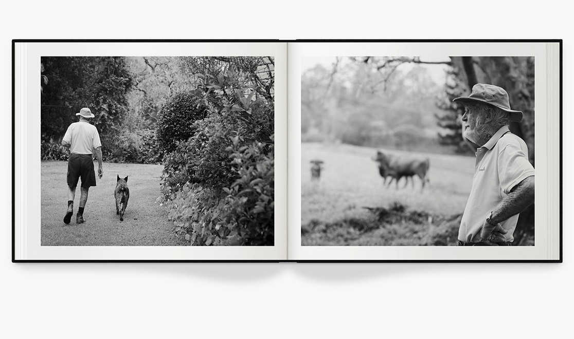 Open photo book with black and white images of a man on his farm