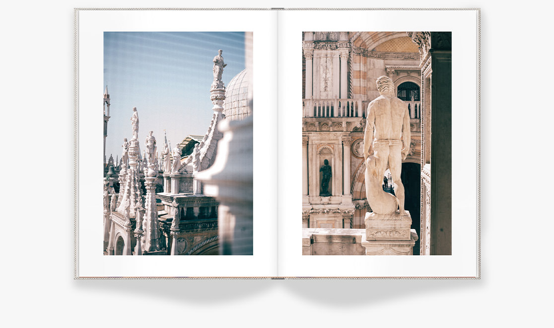 Open photo book with images of monuments in Venice, Italy