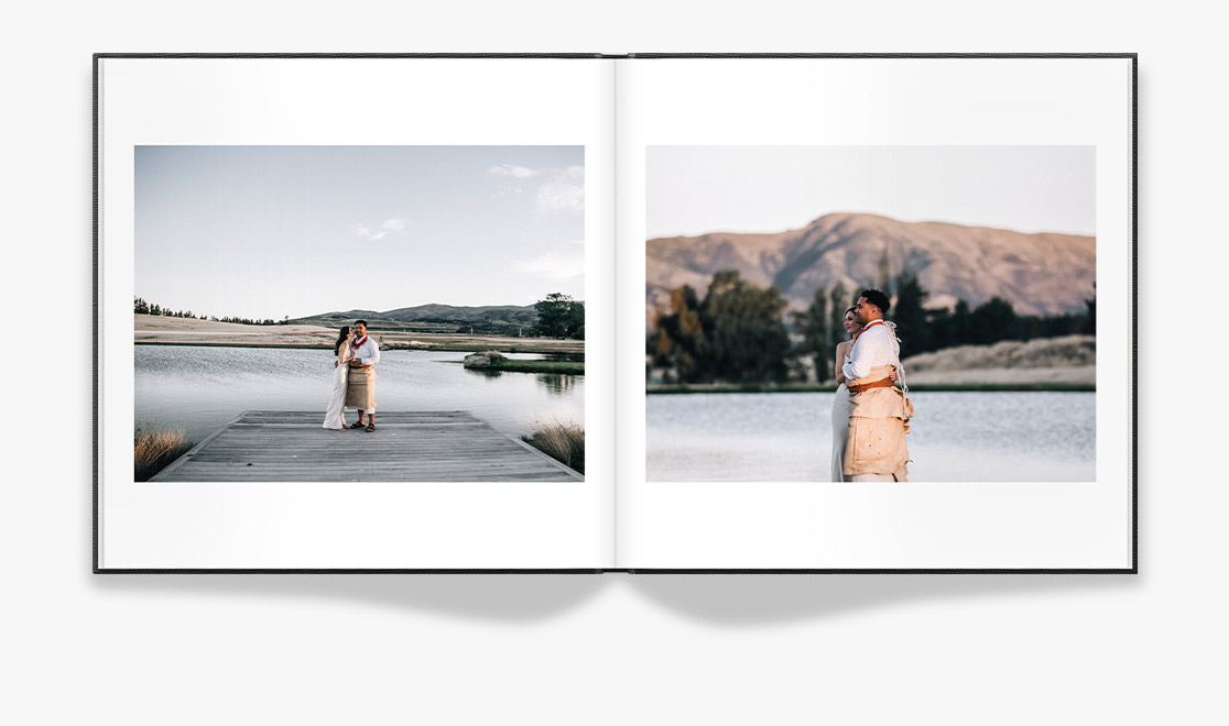 Open Wedding Photo Album showing spread of newlywed portraits by lake