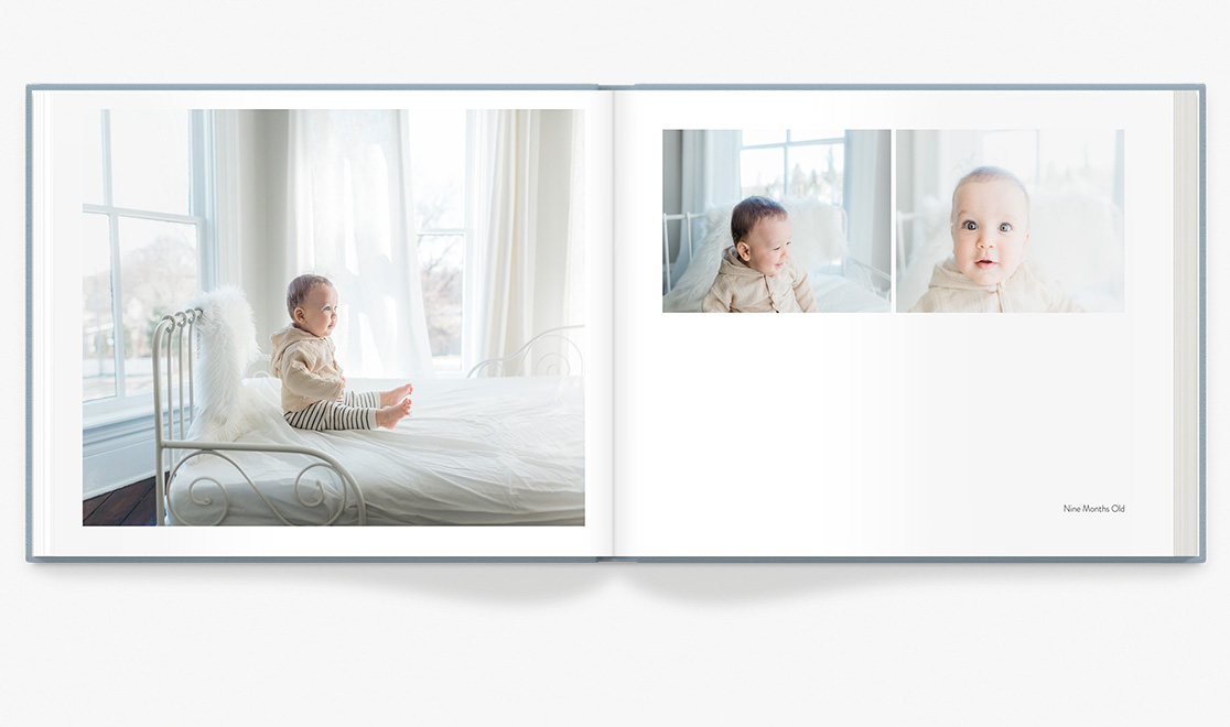 Photo book spread showing baby photos