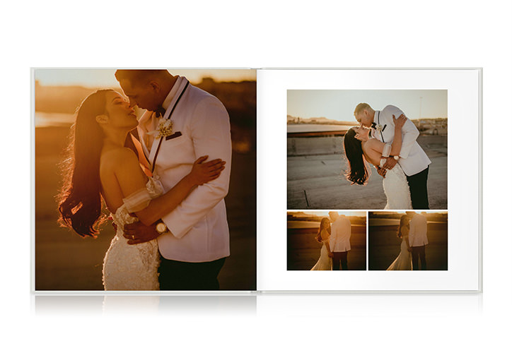 Open photo book showing spread of wedding photos
