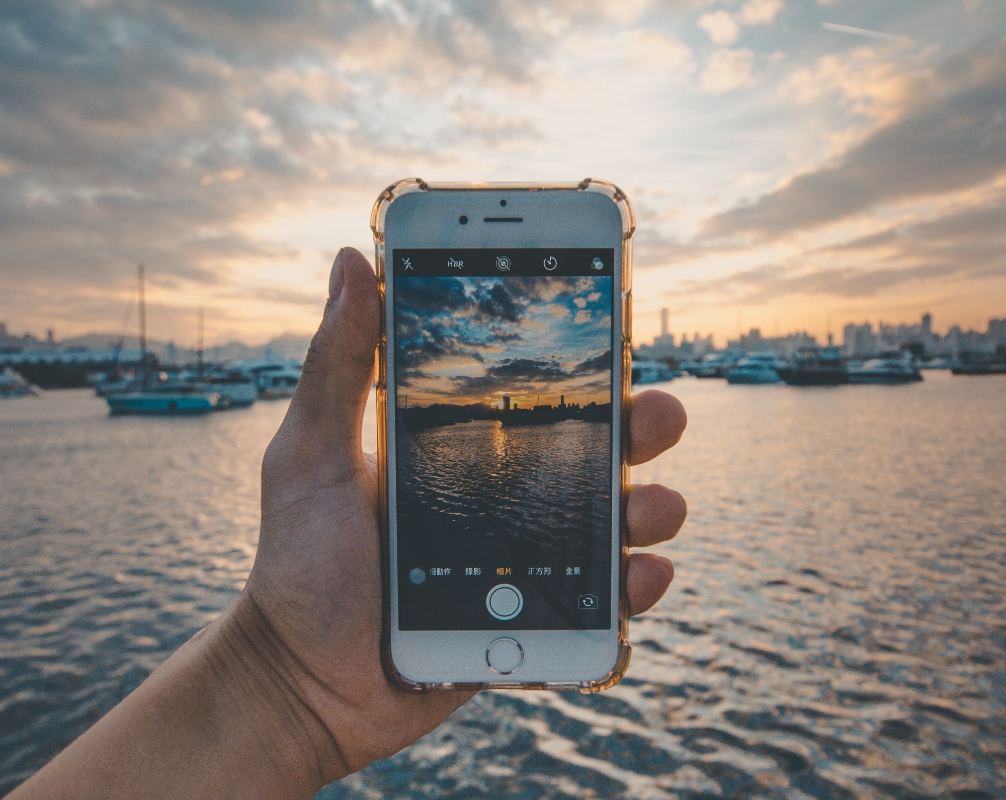 Hand holding iPhone taking a picture using phone camera
