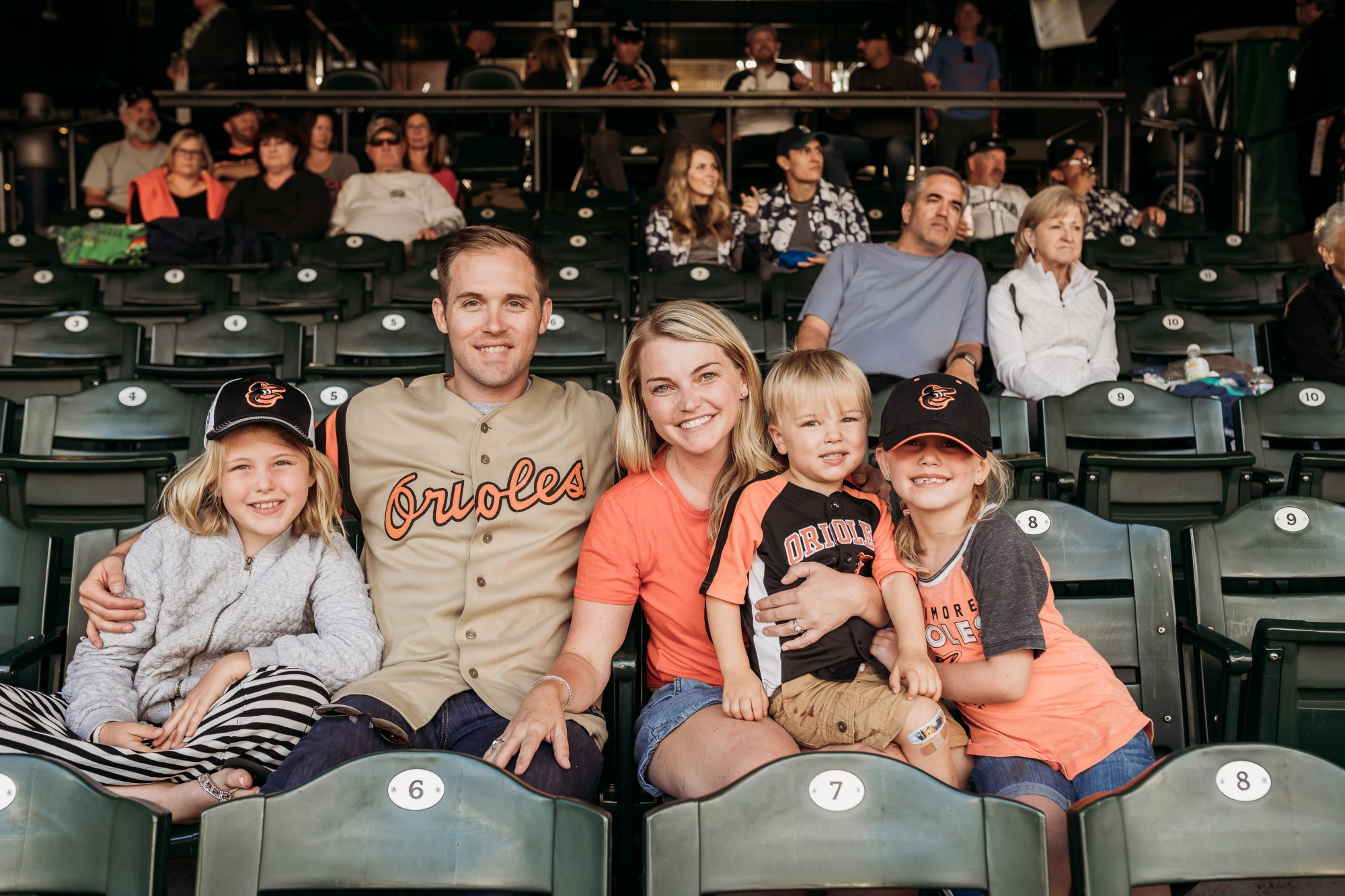Young family in the stands at a baseball game