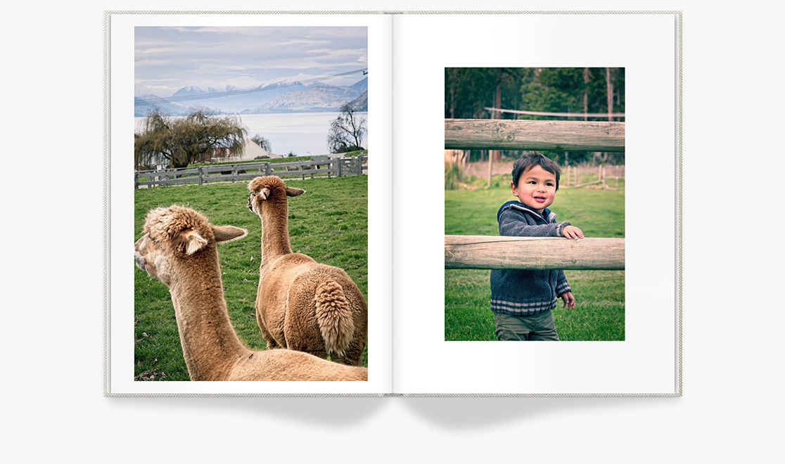 Open photo book showing spread of family photos at farm