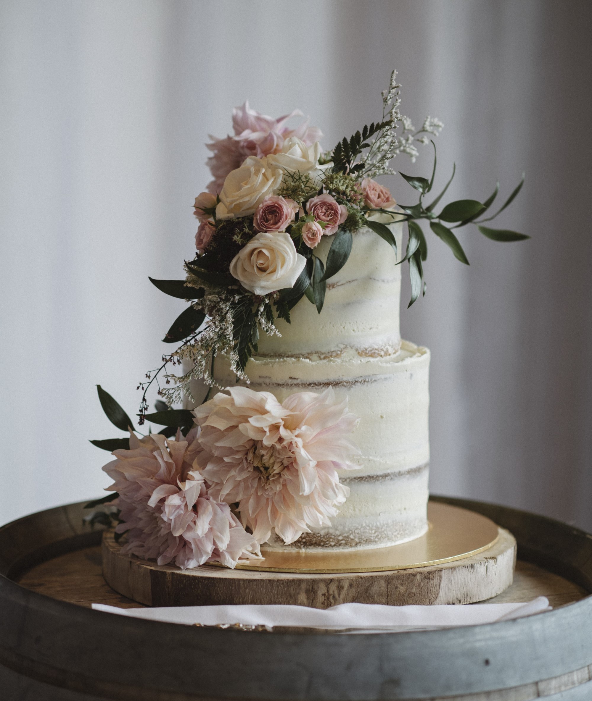 Two tiered naked wedding cake with flowers