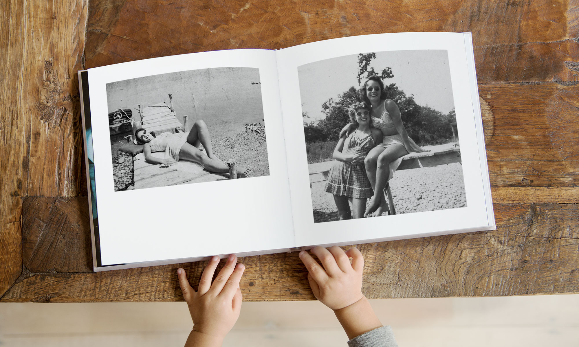 Open photo album on wooden table