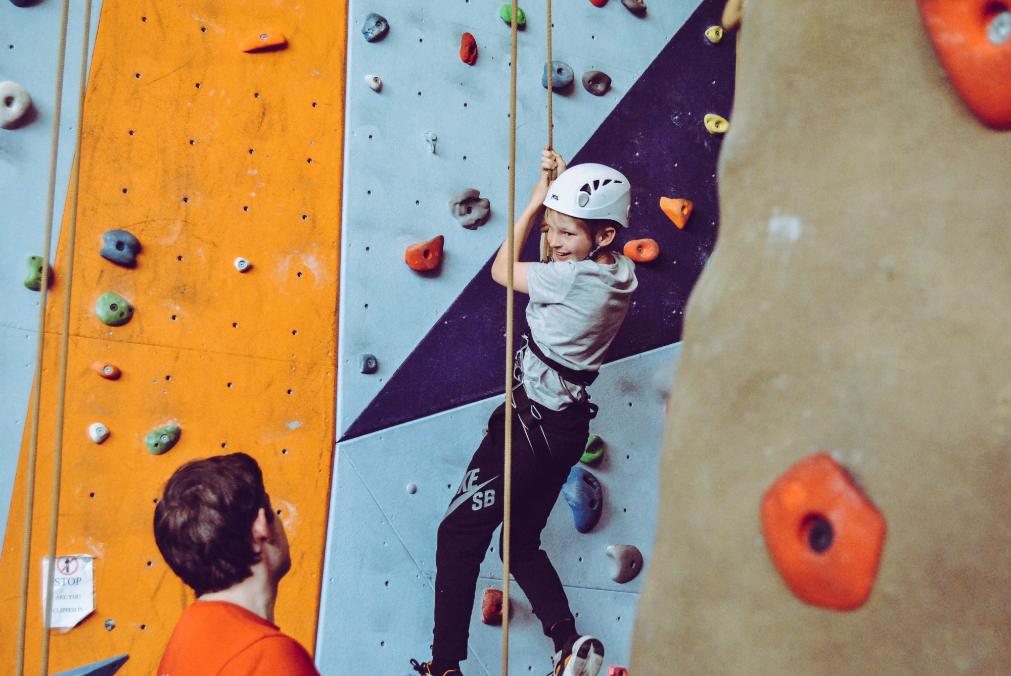 Young boy indoor rock climbing