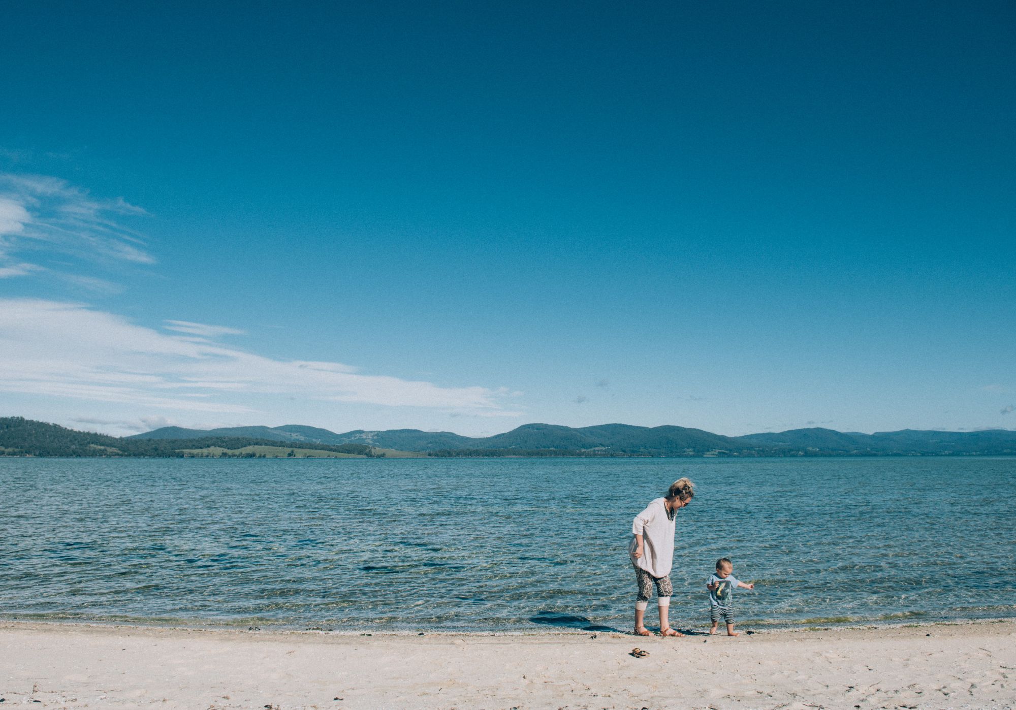 Woman and toddler on beach