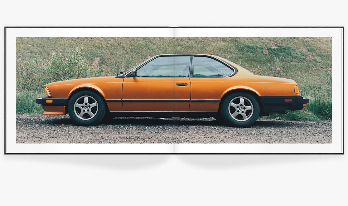 Open photo book showing spread of car image
