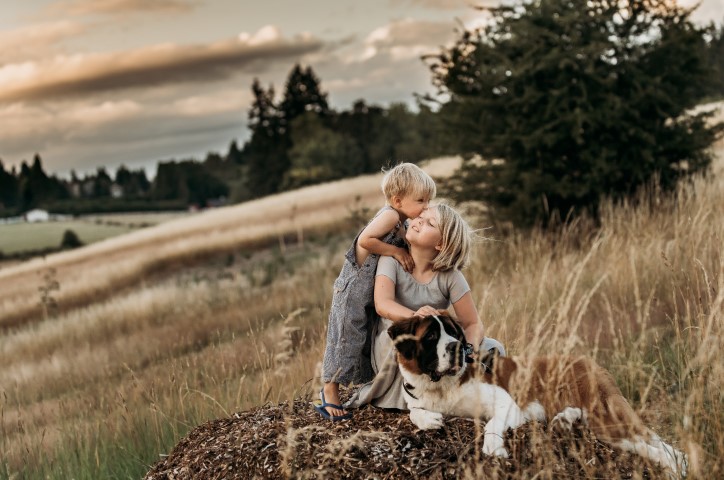 Two children and a dog in a field