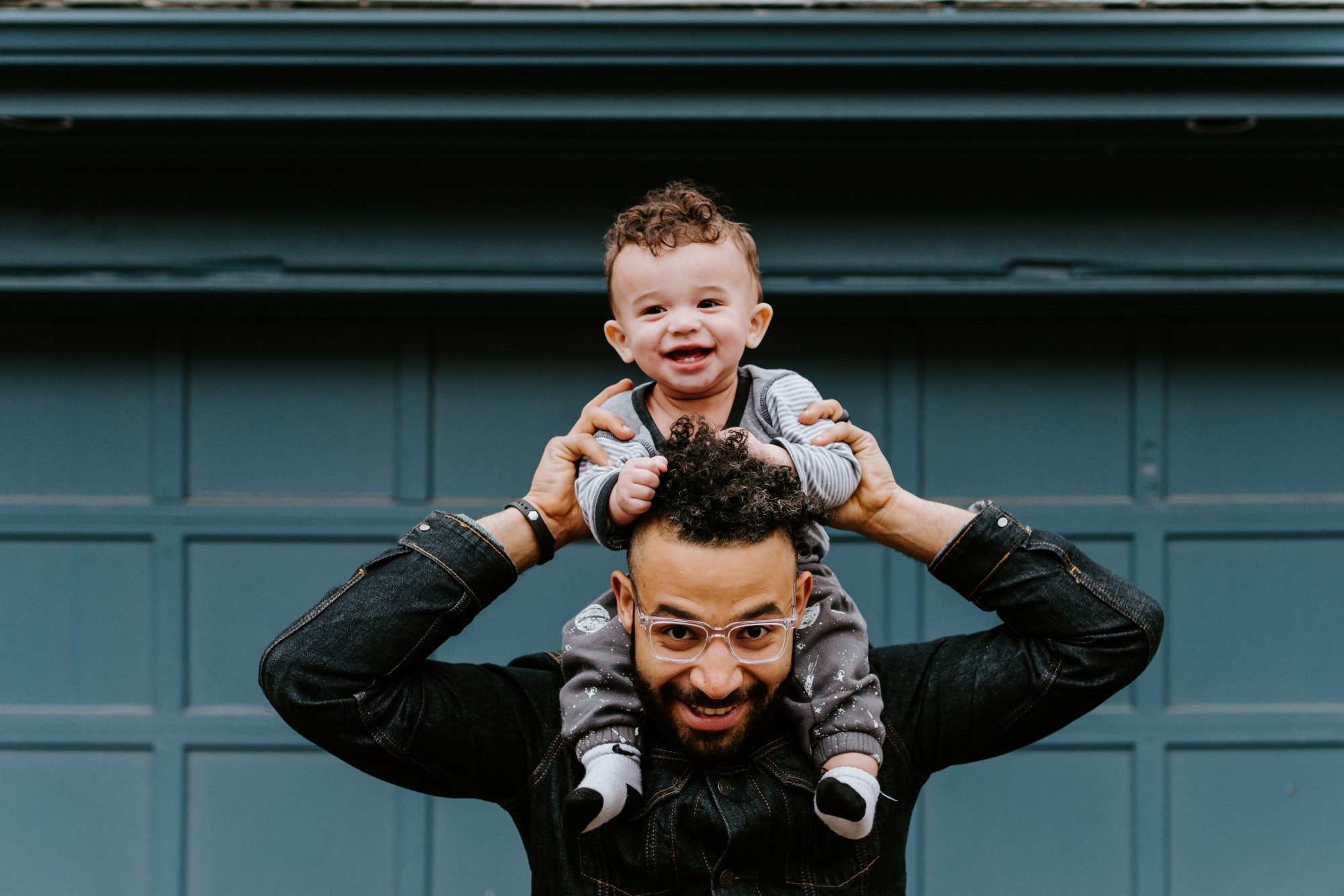 Baby on shoulders of man
