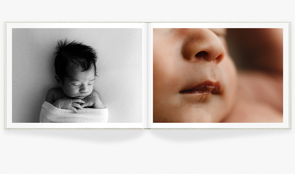 Open photo book showing images of newborn child