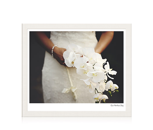Large classic landscape photo album titled our perfect day with a photo of a bride holding a bouquet on the cover.