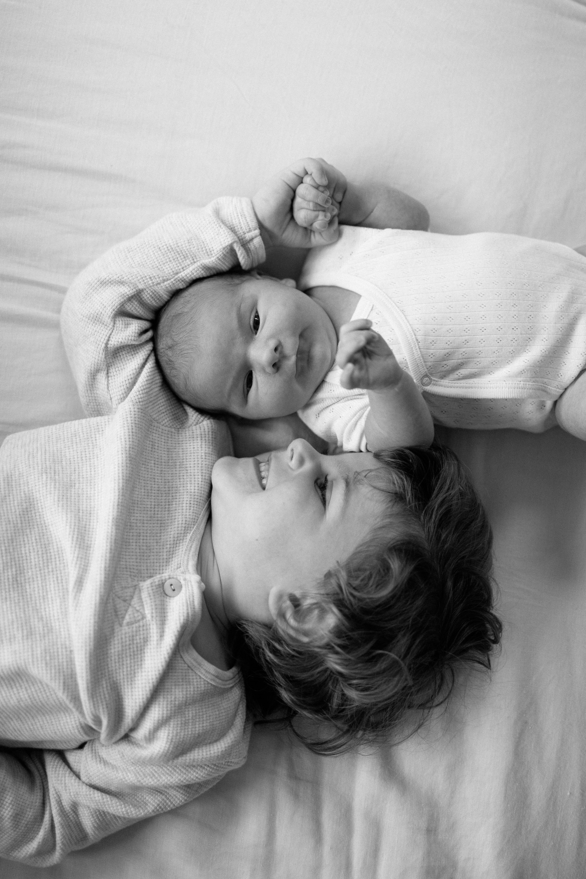 Toddler and child lying together