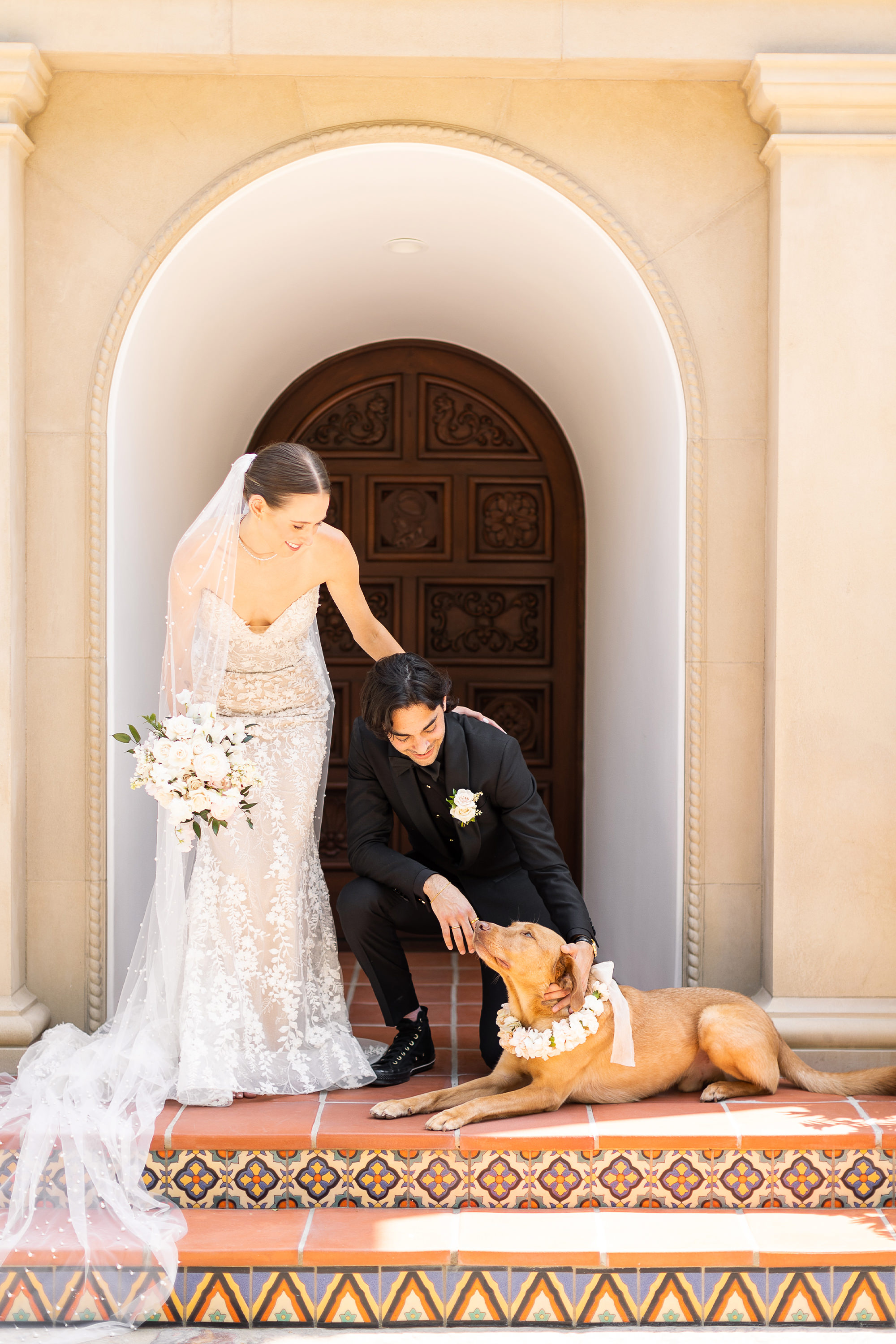 Newlyweds pose with dog