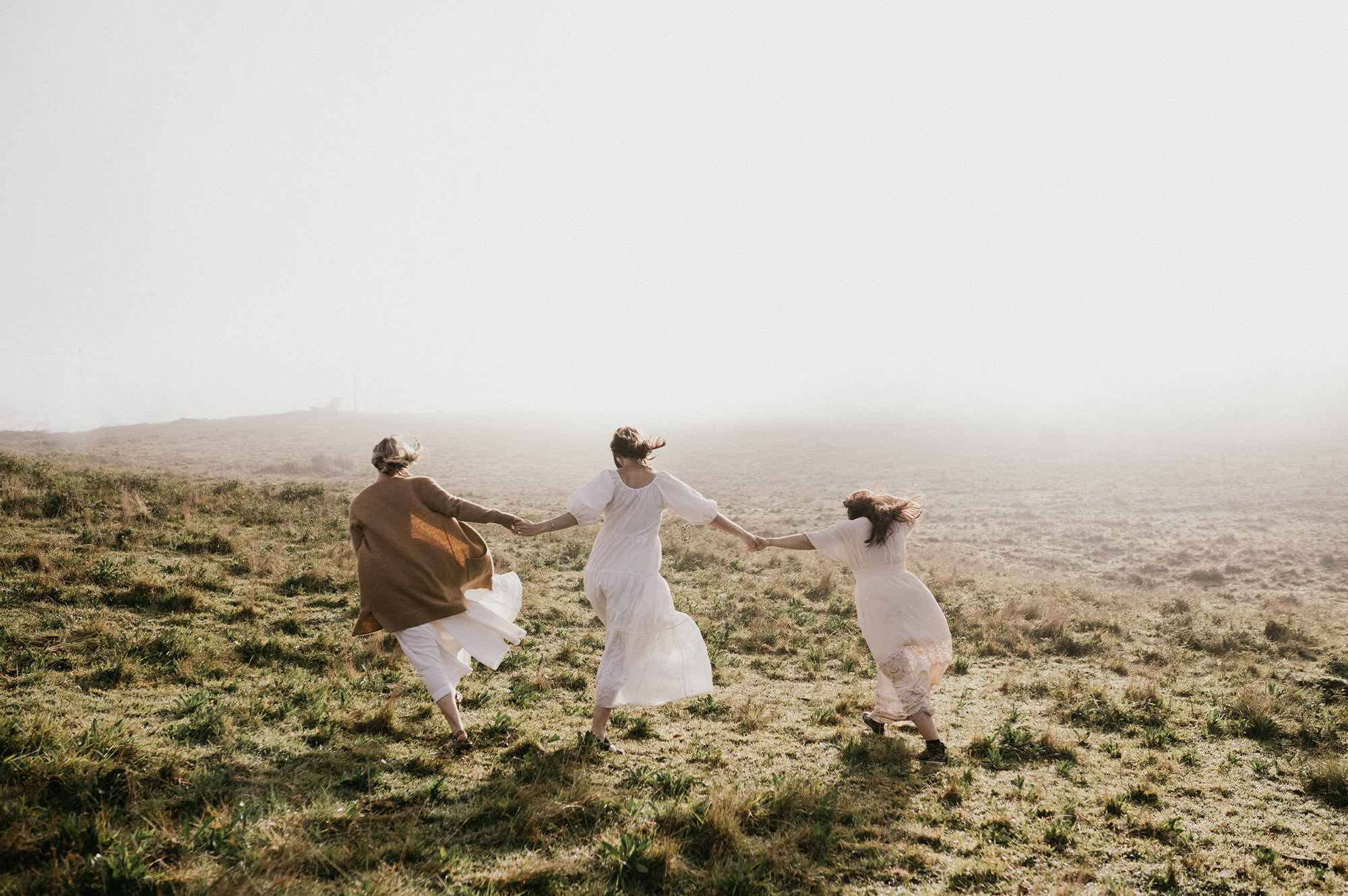 Three sisters holding hand in field