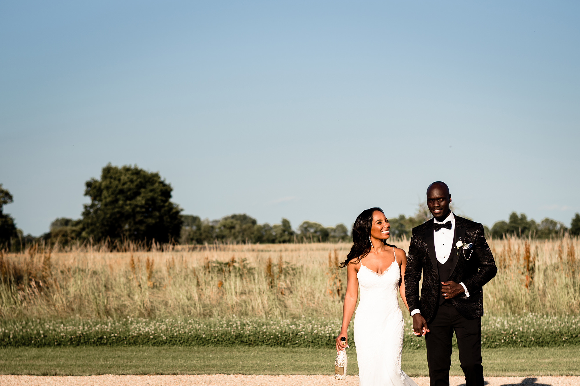 Newlyweds pose in field