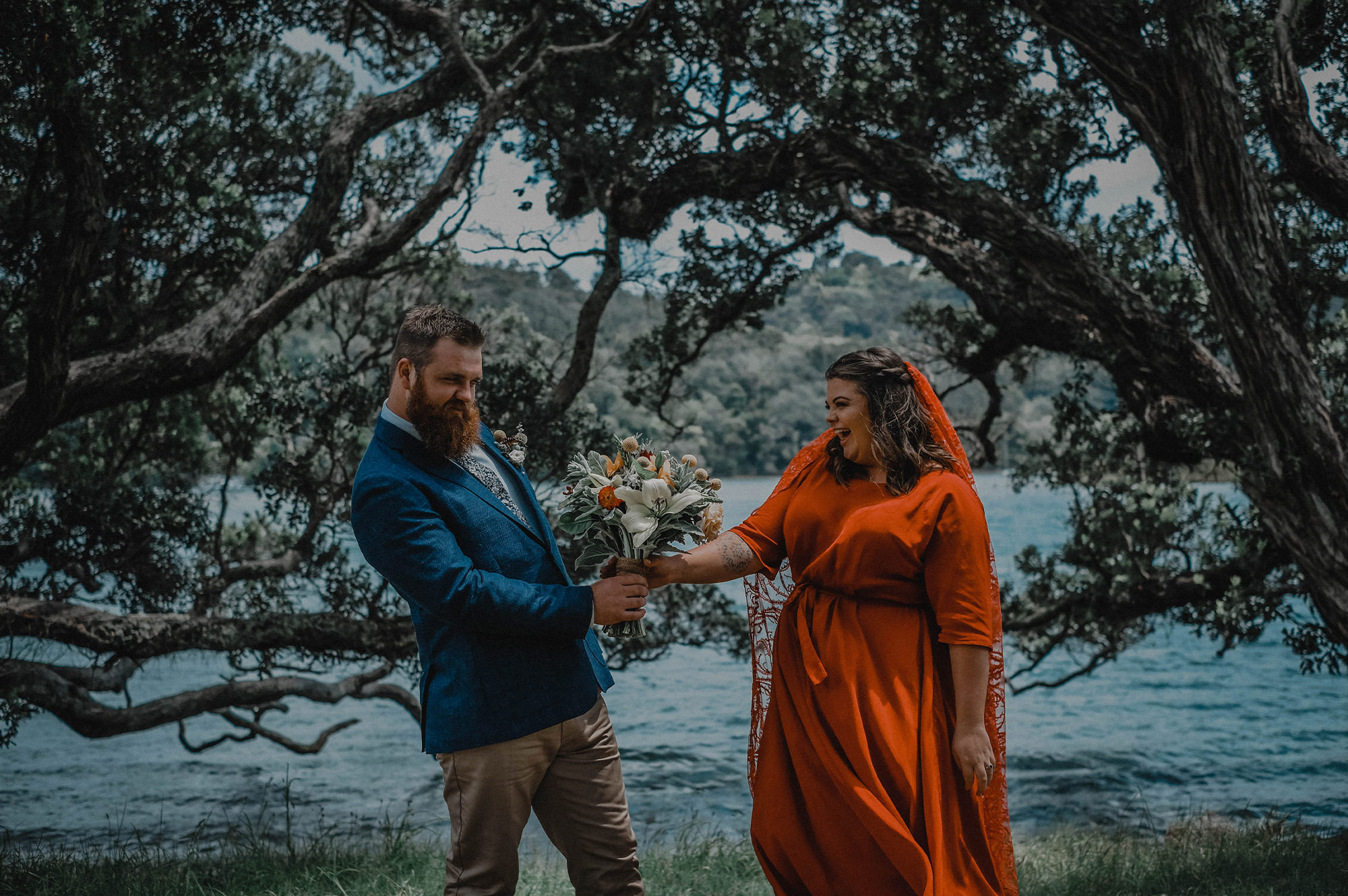 Bride and groom holding bouquet of flowers