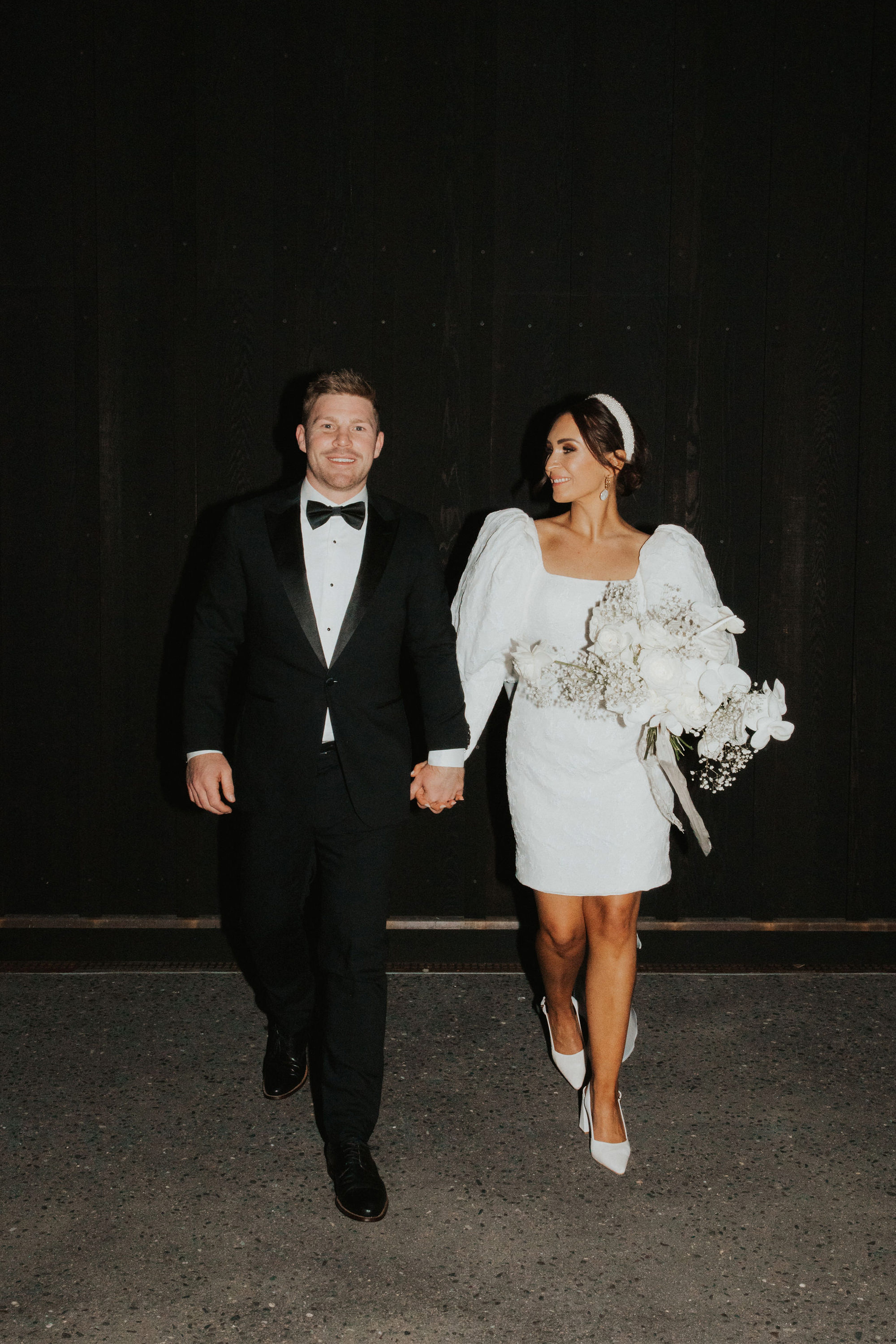 Bride and groom holding hands