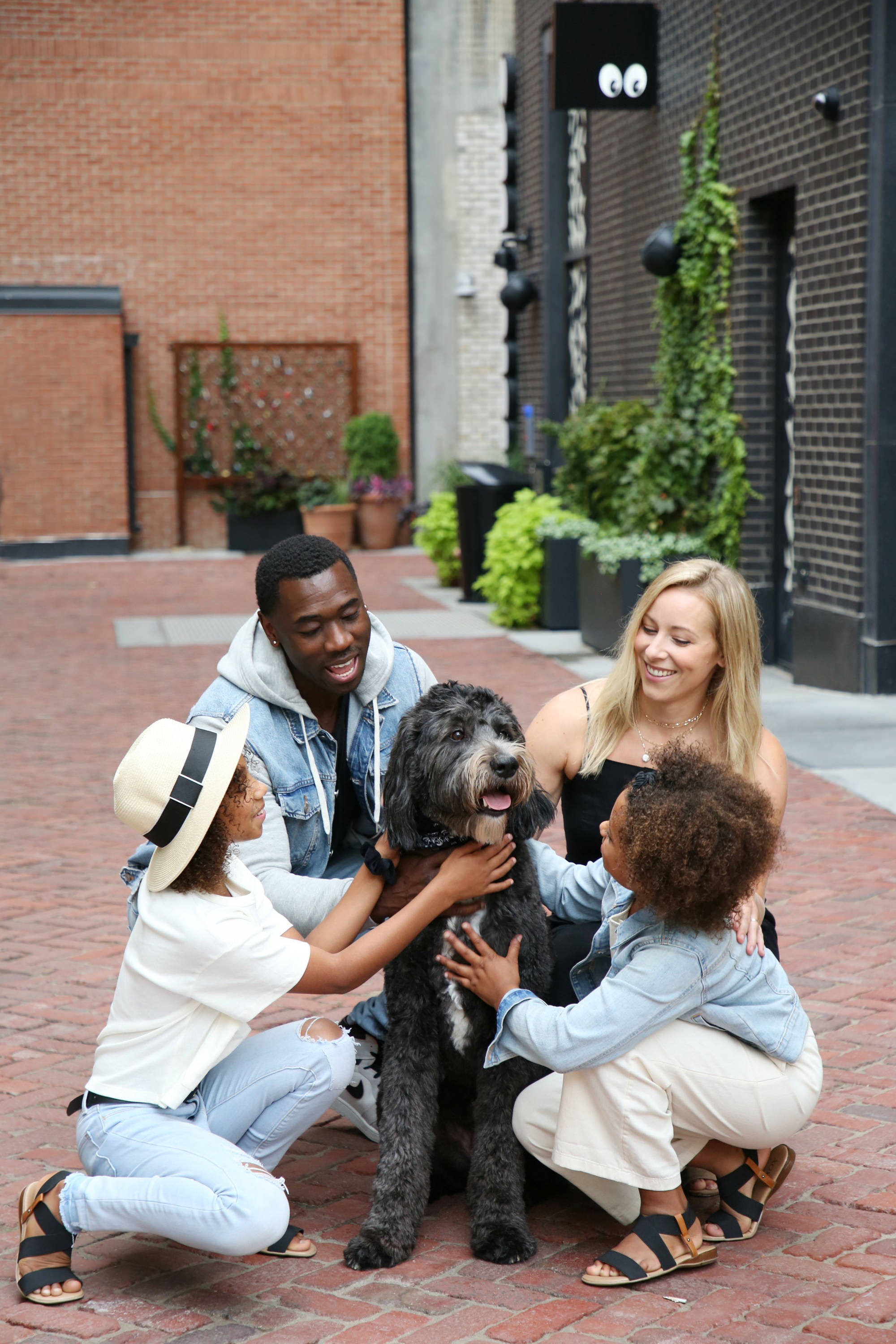 Family with dog on cobblestones