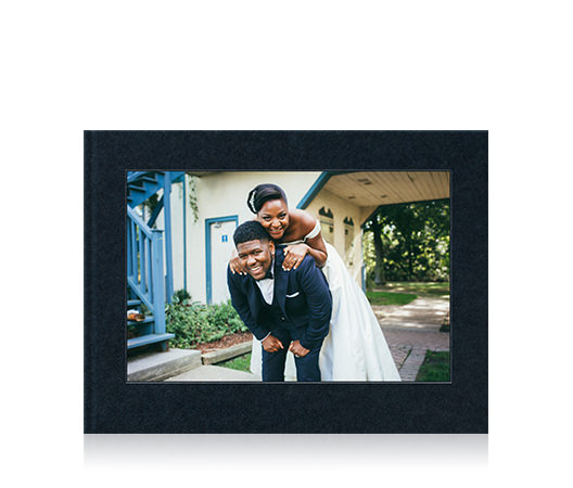Landscape wedding photo book with a cover image of a bride and groom