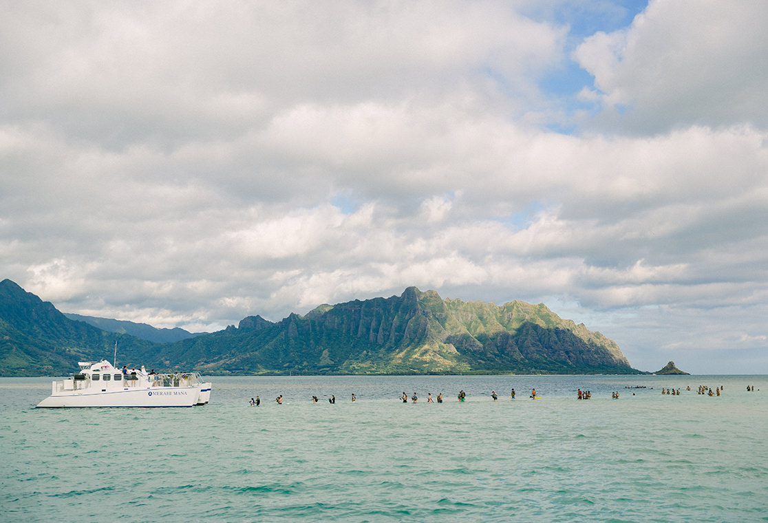 People in the water coming off a boat.