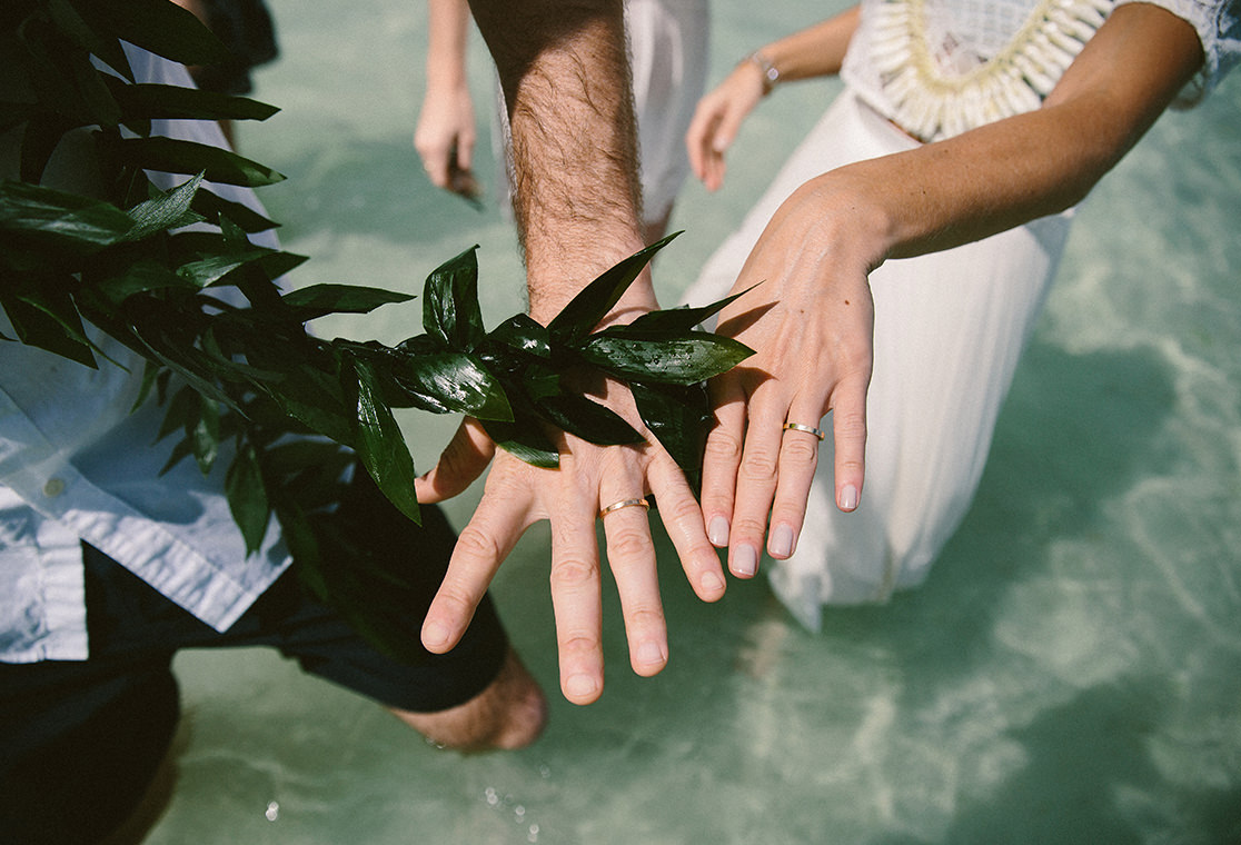 Husband and wife hands with wedding rings.