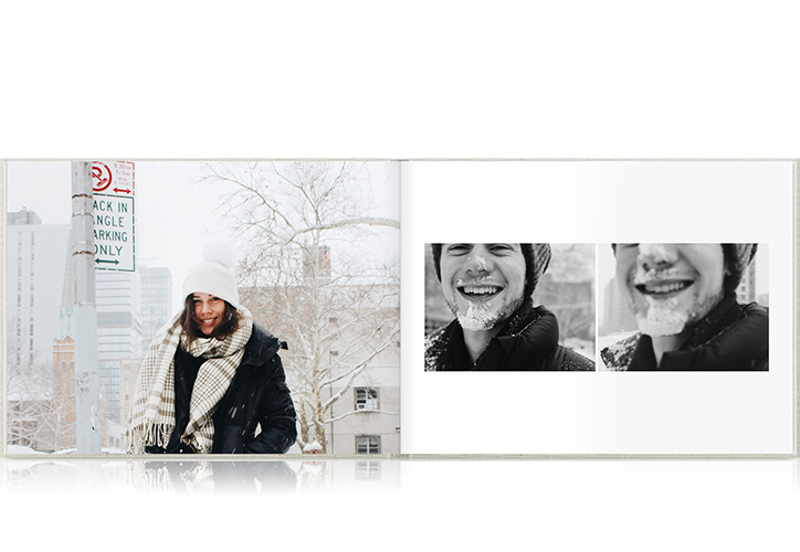 Open photo book showing spread of snowy photos