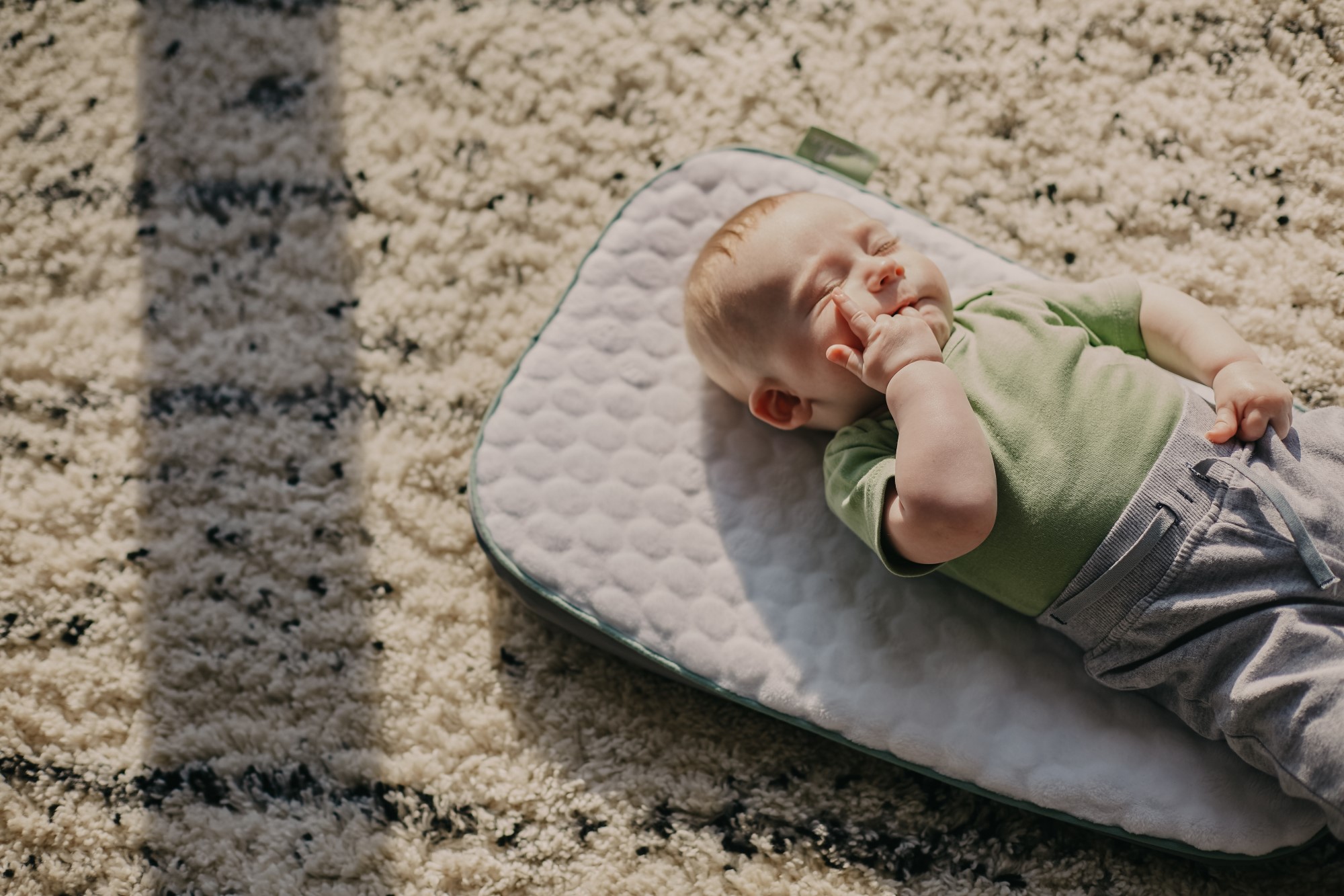 Baby lying on carpet