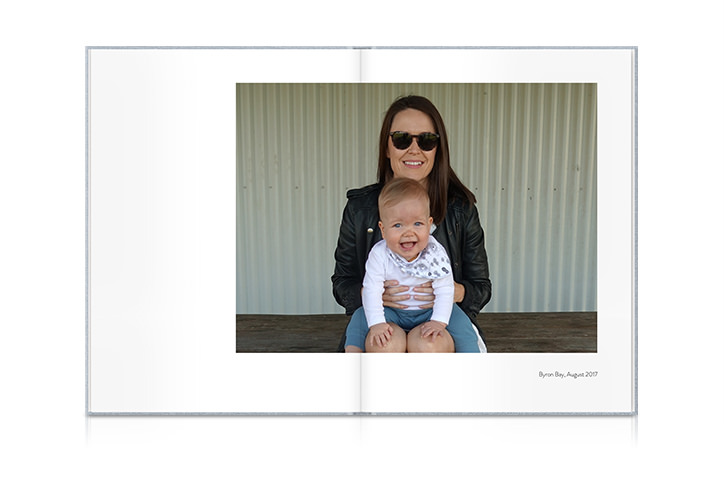 Open photo book showing photo of woman and child