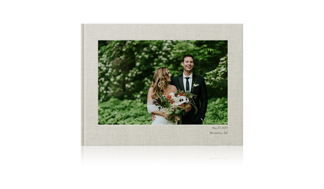 Photo book with cover image of newlywed couple.