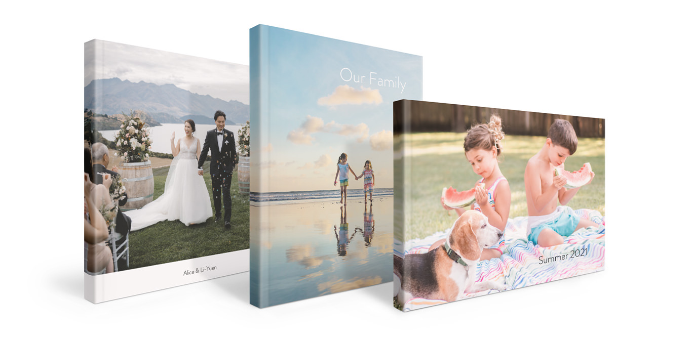 Three softcover photo books with wedding and family images.