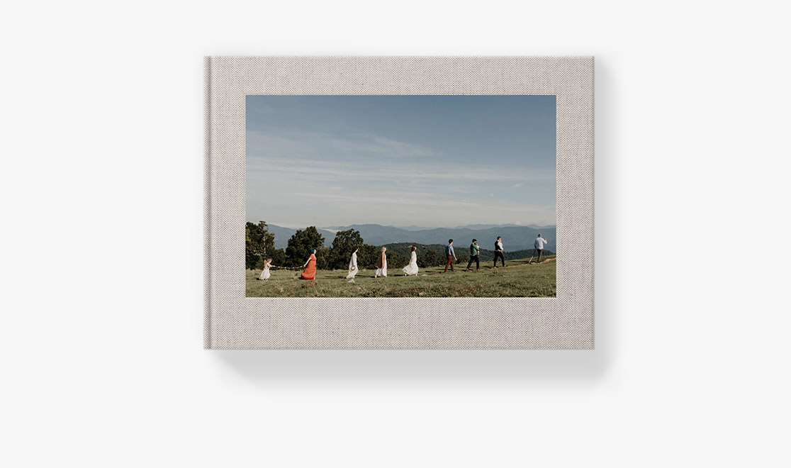 Photo book with cover image of people walking on grass