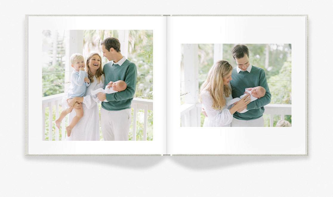 Classic Photo Book showing family laughing, holding newborn