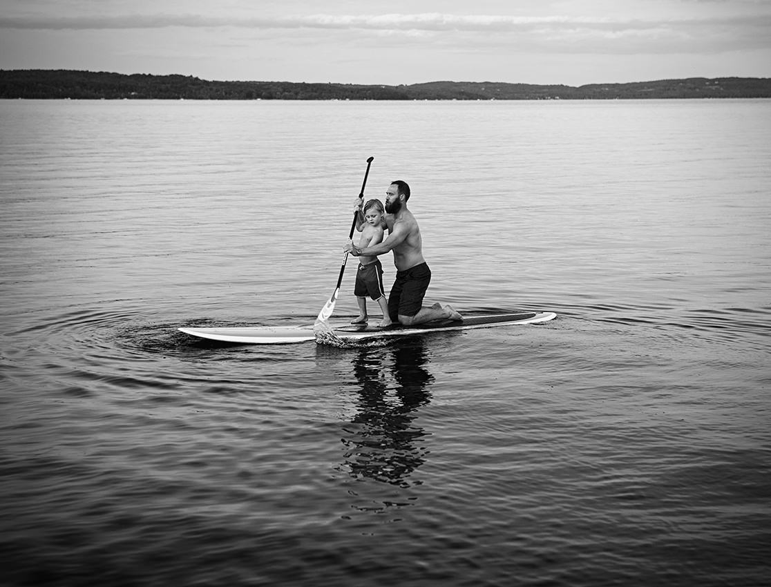Father and son paddle boarding