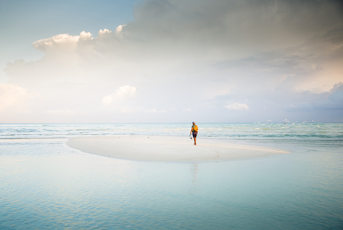 Man by himself at the beach.