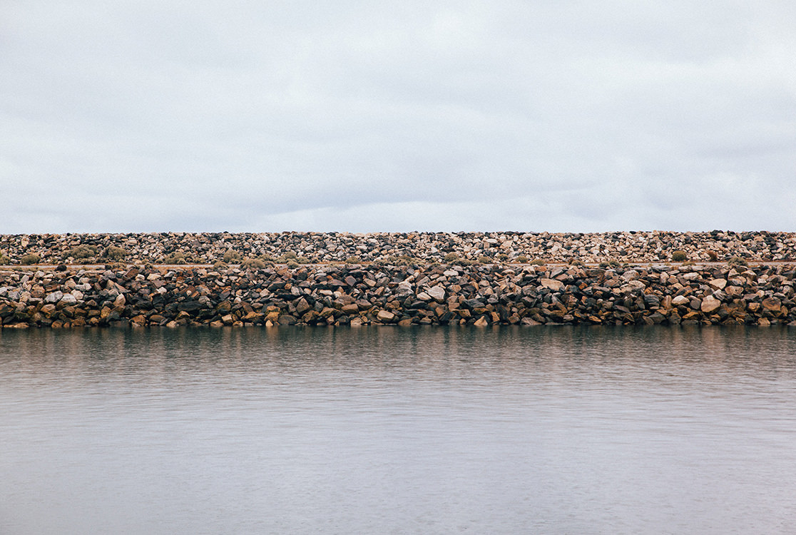 Sea by a bank of stones.