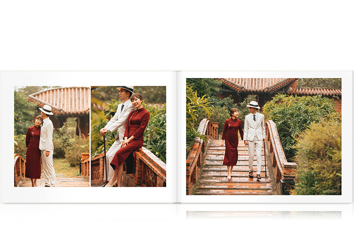 Double page spread of married couple walking through temple