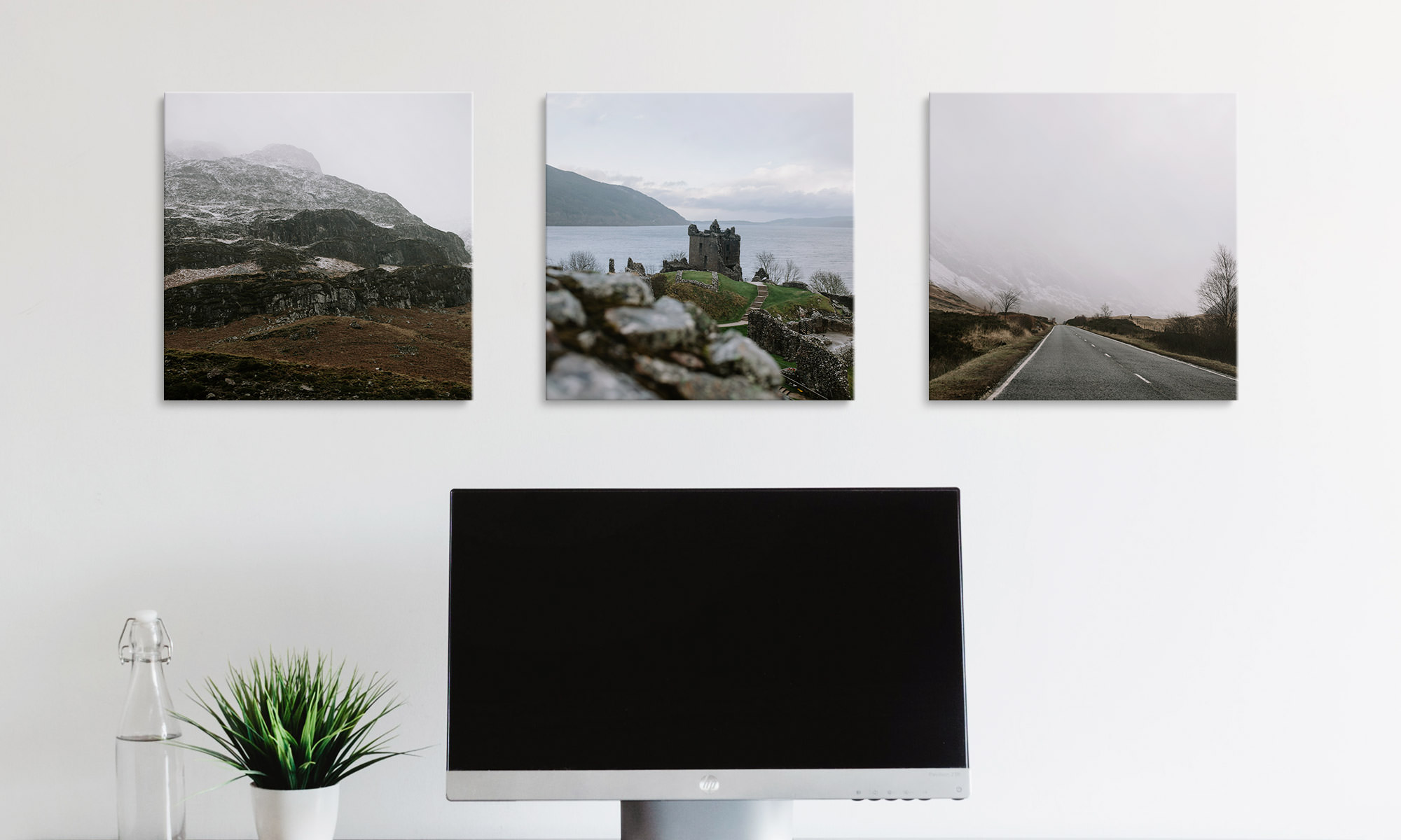 Three canvases hanging in home office