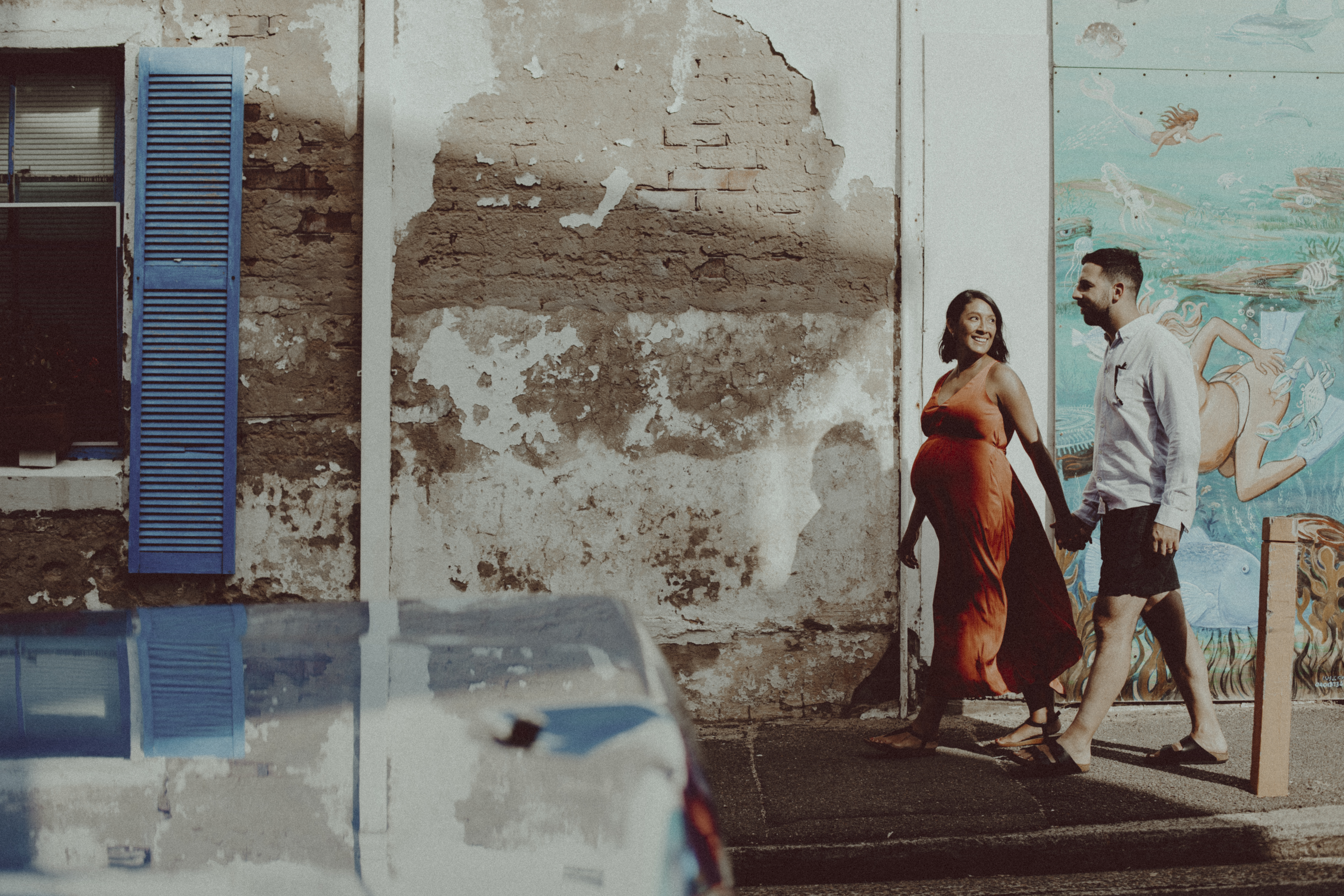 Couple walking hand in hand down street