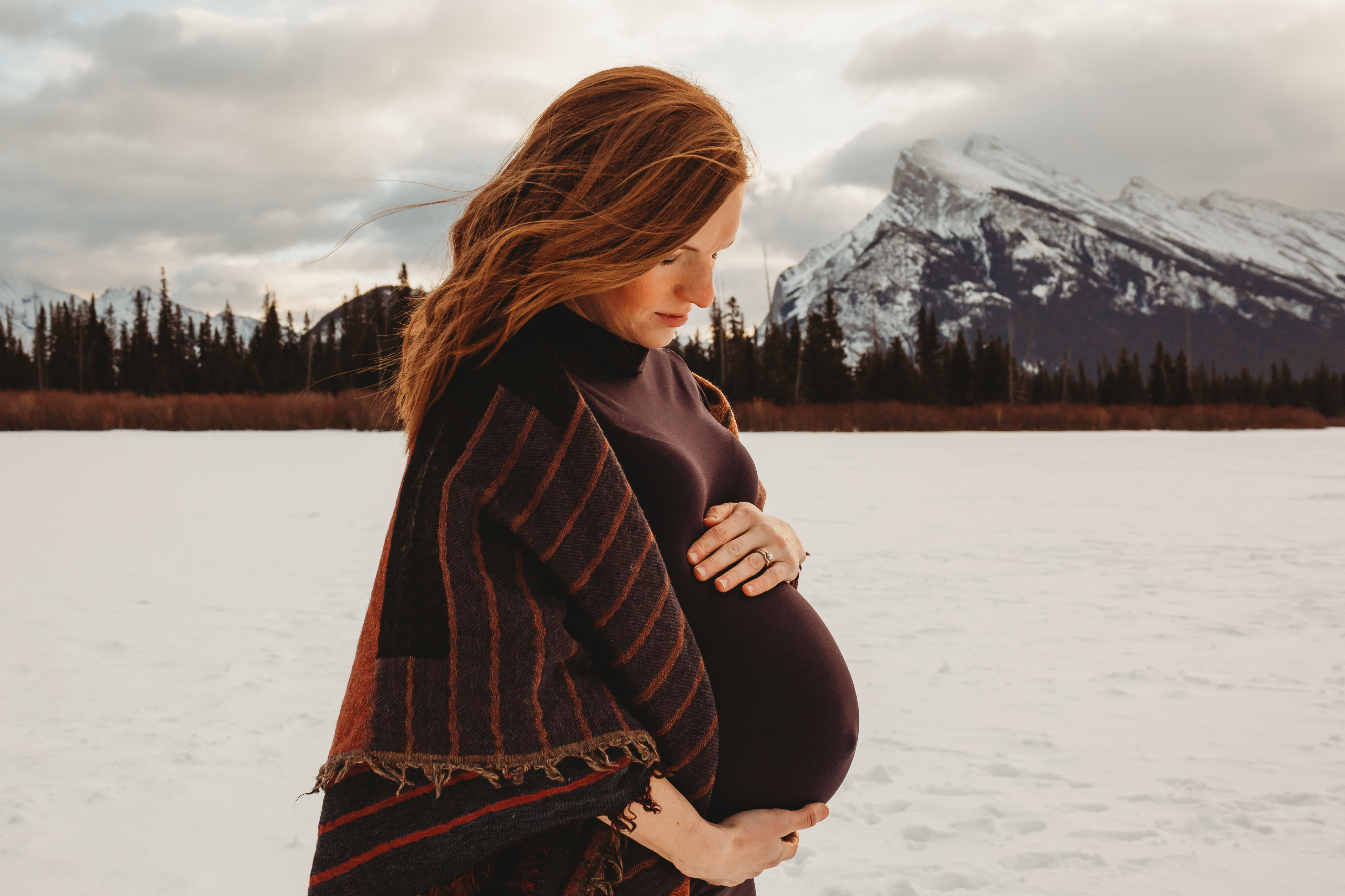Maternity photo shoot of woman in snow