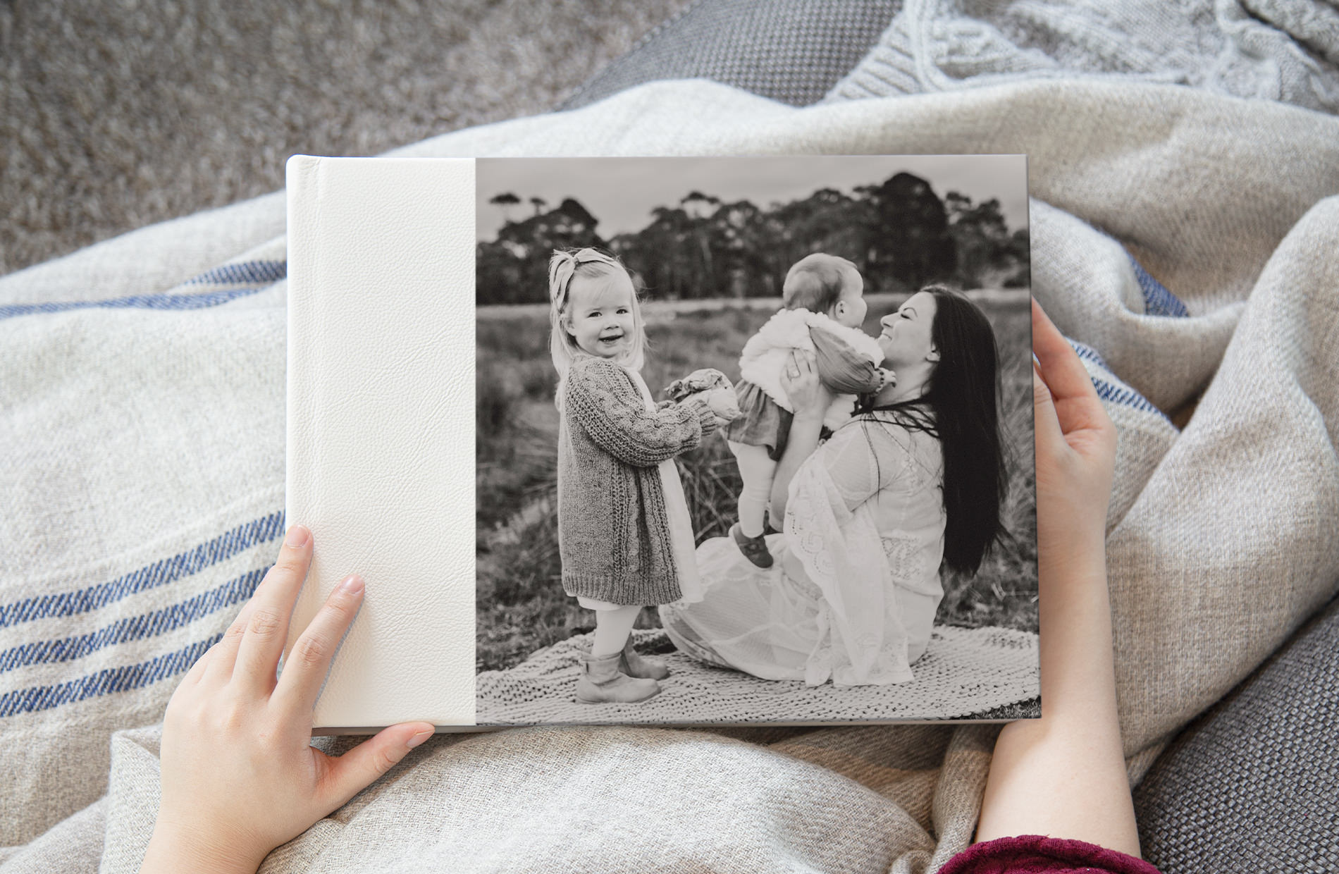 Mother with children in photo album black and white